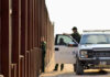 Trump SEPARATES Kids Despite Court-Order Border patrol agents near a tall metal fence.