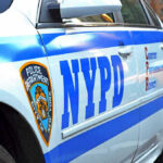 Police Cruiser PLOWS Through Jogger On Routing Call NYPD police car with logo and text.