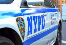 Police Cruiser PLOWS Through Jogger On Routing Call NYPD police car with logo and text.