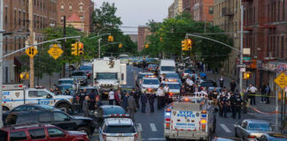 Police activity on a city street with emergency vehicles.