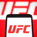 MMA Fighter Found DEAD – Days After Trump Event UFC logo on phone screen and background.