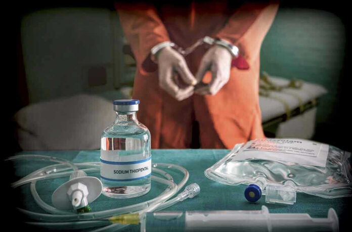 765745765 Vial labeled Sodium Thiopental near handcuffed person.