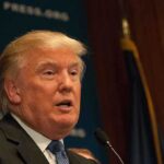 Trump REWARDS Mortgage Boss Top Position! A public figure speaking at a podium during a press conference