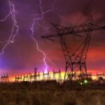 Midwest Blackout Causes Airport CHAOS! Lightning strikes illuminate a power station against a colorful sunset sky