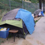 World Cup Clean-Up Sparks Liberal Uproar Tents and belongings set up along sidewalk.