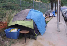 World Cup Clean-Up Sparks Liberal Uproar Tents and belongings set up along sidewalk.