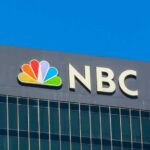 NBC Demand Reporters REMOVE This Phrase From Future Broadcasts! NBC logo displayed on a corporate building against a blue sky