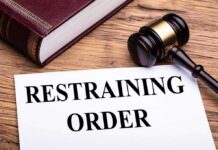 GOP Rep’s Wife Orders Restraining Order After Disturbing Allegations gavel, legal book, and restraining order document on wooden desk