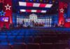 Senate Dem Debate Labeled A Disaster – Can’t Answer ONE Question Debate stage with red and blue lighting and empty audience seats