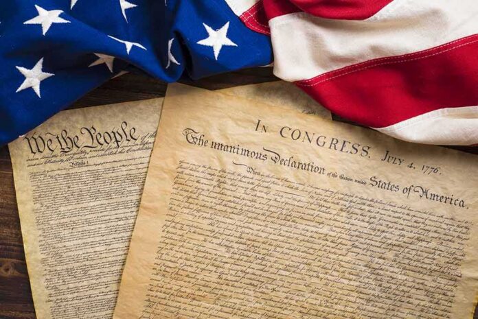 shutterstock_310478060 United States founding documents with American flag