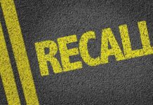 Major Recall Alert: Seats Shifting Mid-Drive yellow recall text on asphalt with double road lines