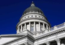 Capitol building dome with columns against a deep blue sky