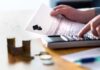 Migrants Granted College Acceptance Priority Over U.S Students! Hands calculating student loan with document and calculator