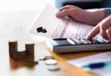 Hands calculating student loan with document and calculator