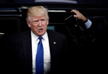 Trump Lands Golf Power Role man in suit stepping out of a vehicle