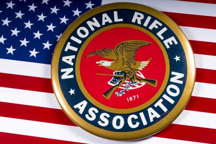 shutterstock_1054857680 NRA emblem on American flag background