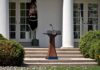 China Establishes Headquarters NEXTDOOR to White House Podium with presidential seal in a garden colonnade