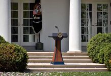 China Establishes Headquarters NEXTDOOR to White House Podium with presidential seal in a garden colonnade