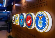 Military department seals displayed on a wall