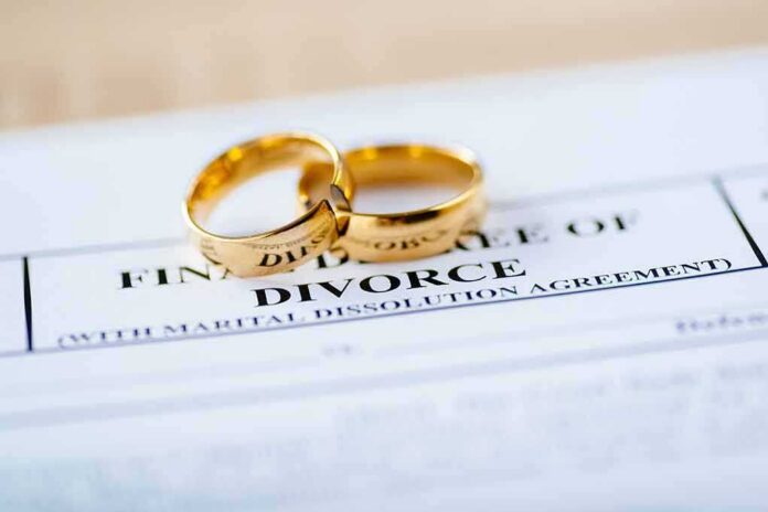 shutterstock_1195555699 Gold wedding rings on a divorce document