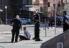 Illegal Alien Assaults Cop, Tries to Steal His Gun Police officers detain a seated man on a city sidewalk
