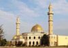 Islamic Prayer RINGS OUT Five Times Per Day Across U.S Cities Mosque with golden dome and two tall minarets under a partly cloudy sky
