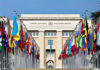 N.Korea Gives Chilling Late-Night U.N Speech United Nations building with numerous national flags outside.