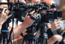 television cameras on tripods at a media event