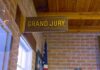 Clancy Juror ATTACKED For Being Republican Grand jury sign in a brick-walled hallway