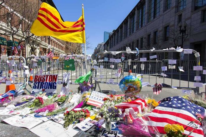 Memorial with flowers and flags by street barricades