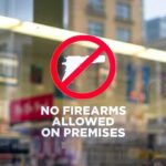 Arsonists Set Themselves Ablaze During Heist! No firearms allowed sign on a store window