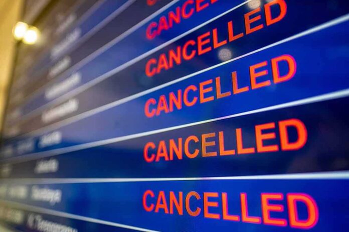 airport departures board showing multiple cancelled flights