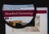 Close-up view of Stanford Universitys website through a magnifying glass