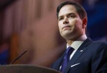 Nazi Meme Torches Rubios TOP Aide man in suit speaking at podium
