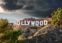 Hollywood sign on hillside under dramatic clouds