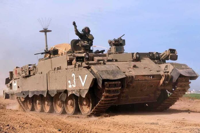 Armored military vehicle driving on a dirt road
