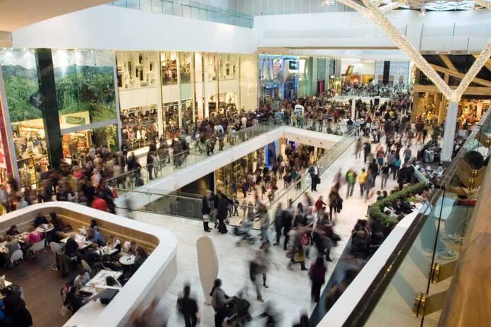 Crowded shopping mall interior with multiple levels