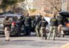 Cop Turns Spy – 4,000 Plate Lookups Police and sheriff officers gather around vehicles on a suburban street