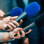 Disgraceful MLB Fans HARASS Christian Pitcher Reporters holding colorful microphones