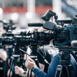Disgraced GOP Rep Seeks Re-Election Days After Losing! Broadcast cameras on tripods at a press event