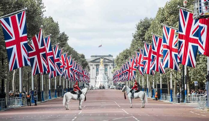 shutterstock_2202756497 Union Jack flags line a broad avenue with mounted guards