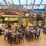 Mall Dispute Erupts – Two Dead! Food court with diners seated at tables near market-style food stalls