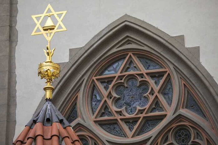 shutterstock_785815858 Star of David atop synagogue roof with stained glass window