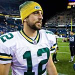 Former Rep MTG Says: Trump To Nuke Iran SOON Aaron Rodgers in a Green Bay Packers uniform on a football field