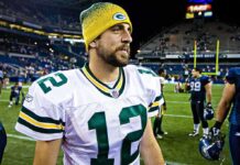 Aaron Rodgers in a Green Bay Packers uniform on a football field