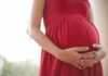 Disgusting Influencer Auctions To Abort Her Babies! Pregnant woman in a red dress holding her belly
