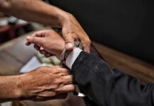 Mayor ARRESTED – Charged With Grand Theft Auto hands placing handcuffs on a suited person's wrists
