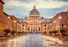 Vatican Bombshell: Pope’s Cancer Confirmed St. Peter's Basilica at the end of a wet street at dusk