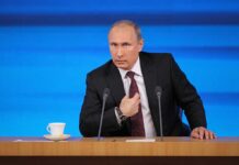 Trump Calls Putin After SECOND Plague Death Vladimir Putin at a podium with two microphones