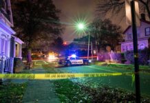 Nine Dead, Including 2 Kids in Erie Home Shooting Police car blocks residential street at night behind caution tape